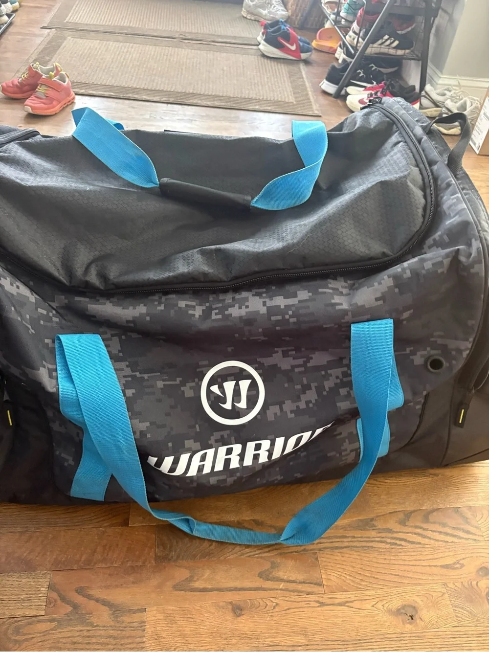 Men's hockey Duffle Bag in Black Digital Camo with Blue Accents wheeled